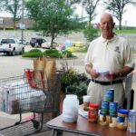 Bob Sfreddo of the Jefferson City Breakfast Rotary Club collects food and monetary donations outside HyVee.