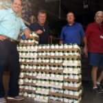 Lake Ozark Rotarians (left to right) Steve Herman, Clint Ladouceur, Kevin Wood and Tom Walker unload cartons of canned goods at Hope House in Eldon.