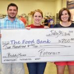 Columbia Rotaract members Josh Beck, Jolyn Sattizahn and Kate Gruenewald present a “check” for $200 to the Food Bank of Central and Northeast Missouri. They also collected 18 pounds of food and volunteered 28 hours.