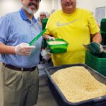 Rotary presidents Todd White of Columbia Sunrise Southwest and Charlie Anderson of Fulton help out at the food bank.