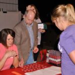 Alaina Leverenz places her bets with Brandy Reagan and Bob Hansen.
