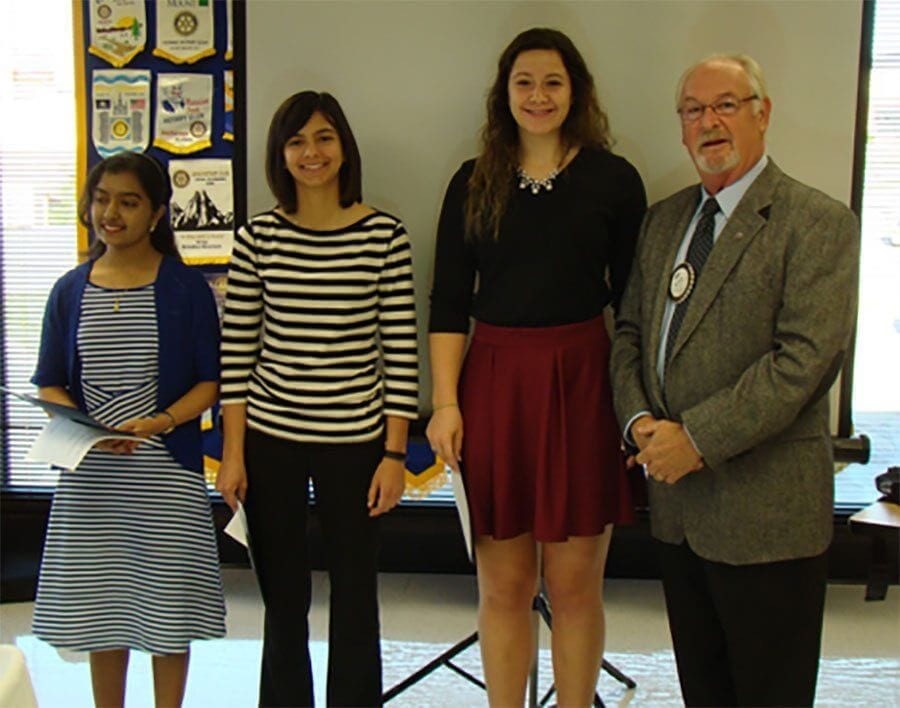 Club President, Bob Asahl, presenting the scholarships to (l to r) Srikavi Premanth and Emily Scully of Jefferson City High School and Olivia Johanns of Helias Catholic High School.