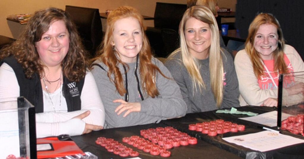 Hannah Mansell, Hope Wallace, Mallory York, Emily Gast, members of the Rotaract Club of William Woods University, work the betting table at last year’s event.