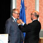 Larry Lunsford pins the Past District Governor's pin on David Bixler.