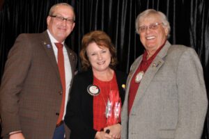 David Bixler presents Rotarian of the Year award to Susan Hart with assistance from Raymond Plue